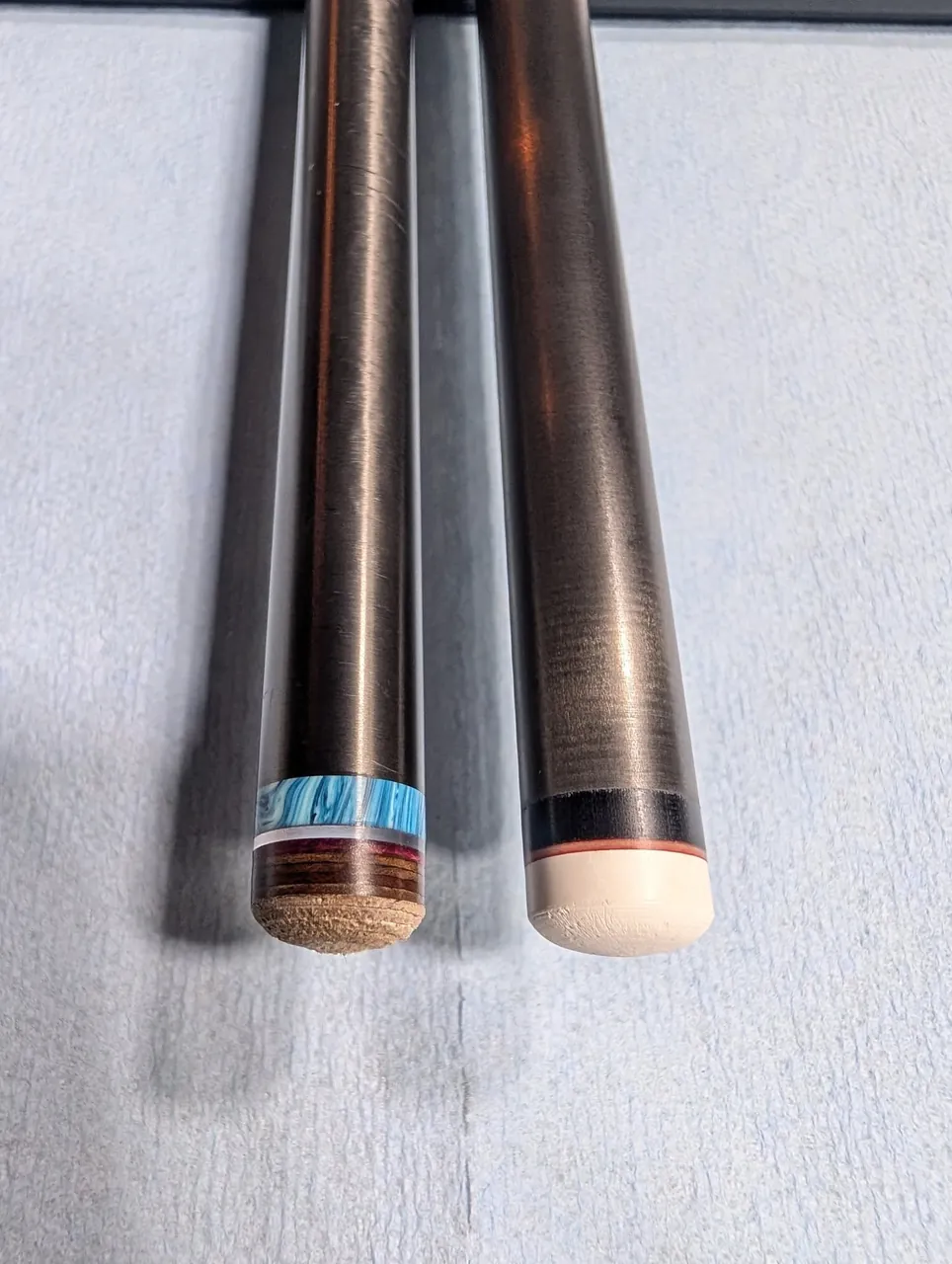 Wheat State Cues Gen 5 Pro carbon shaft lineup with engraved logos.
